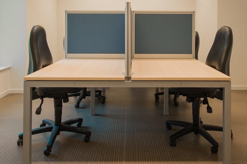 white cubicle with rolling chairs